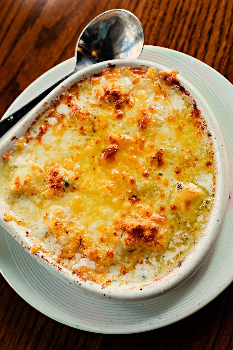 Truffled gnocchi baked in a dish, the top browned and bubbling