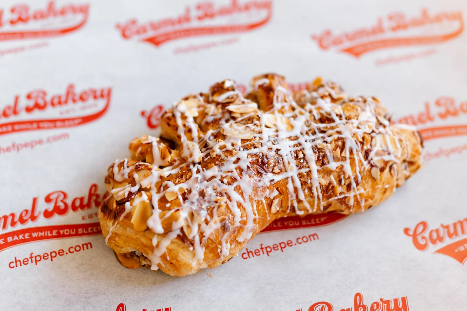 A bear claw with an icing drizzle