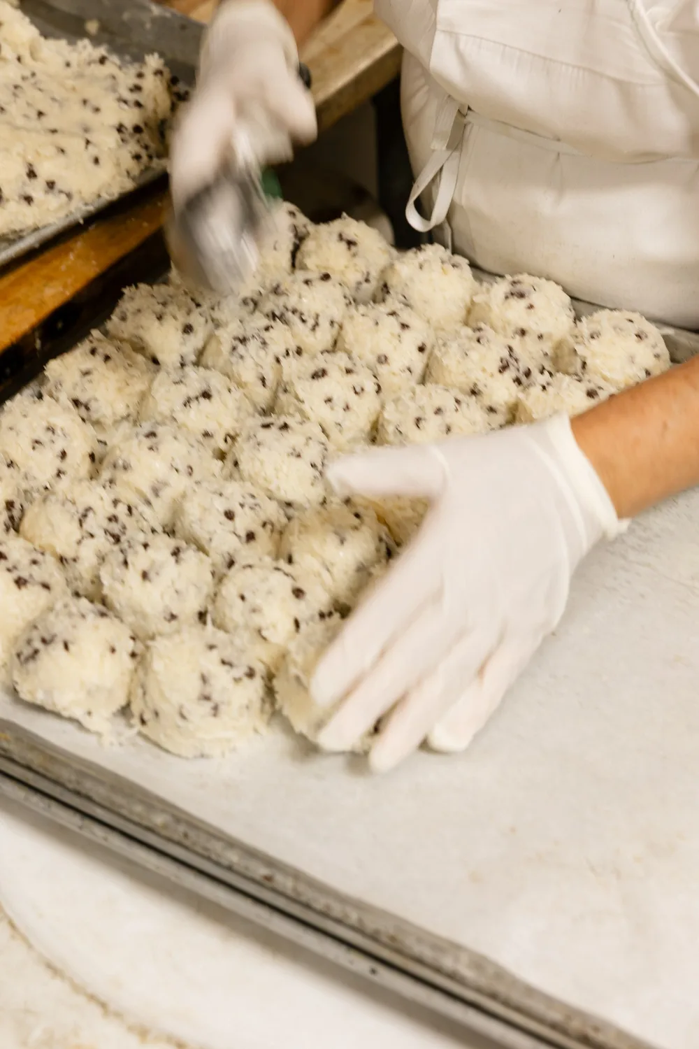 Gloved hands working chocolate shortbread dough