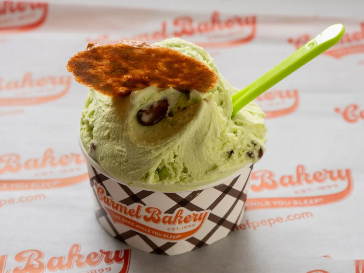 Pistachio gelato in a Carmel Bakery cup with a cookie