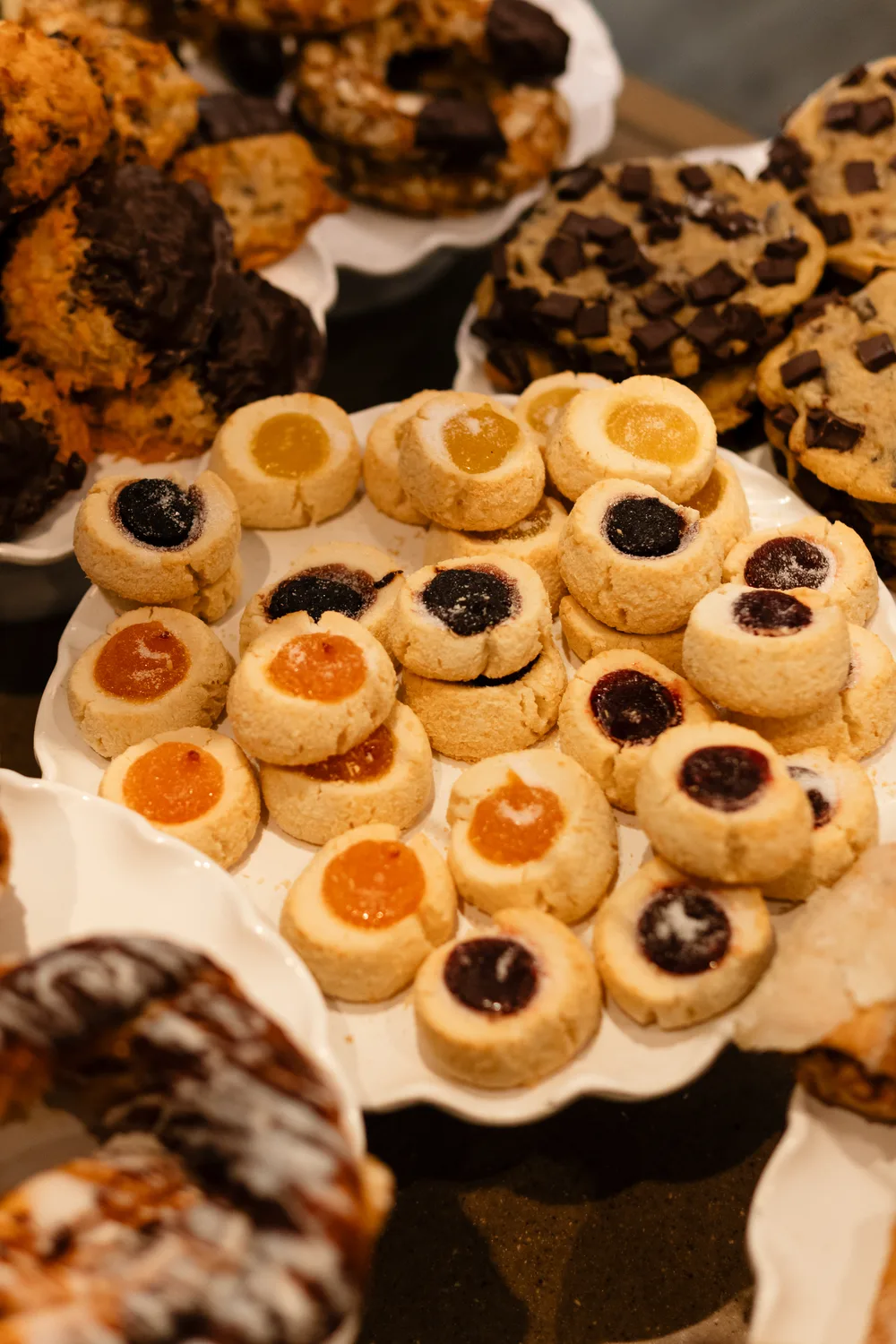 Thumbprint cookies with jam, on a tray in the case
