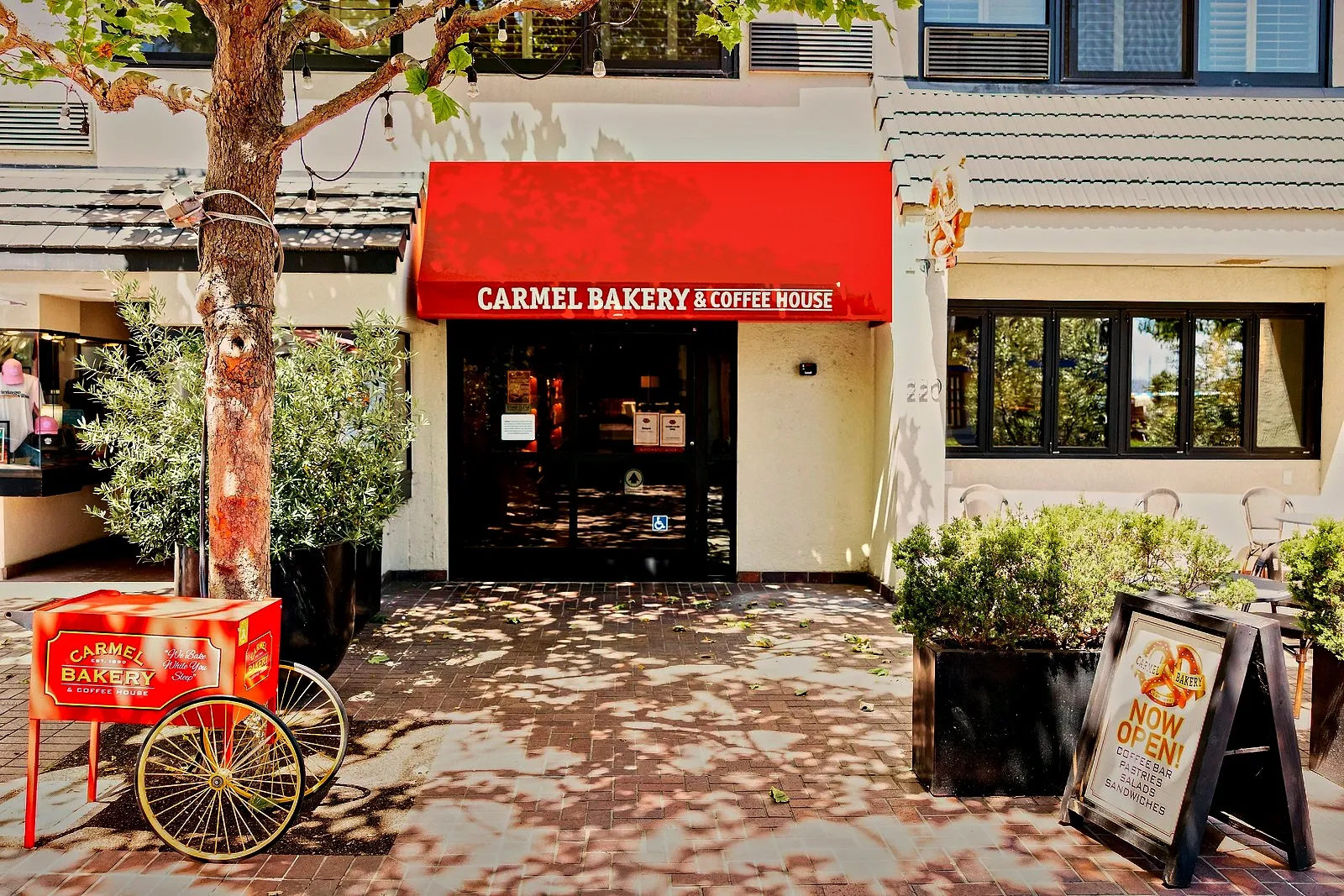 The Carmel Bakery storefront and red bakery cart at Portola Hotel & Spa, Monterey