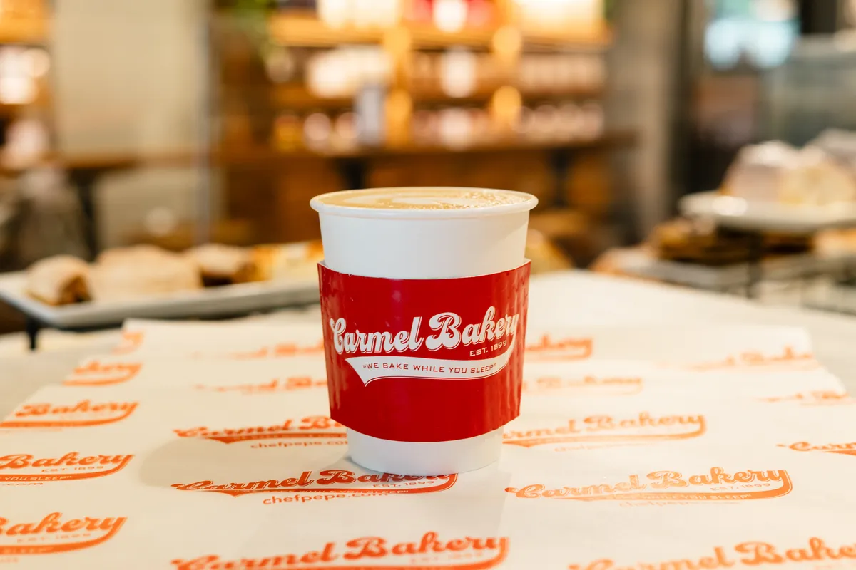 A latte in a Carmel Bakery cup