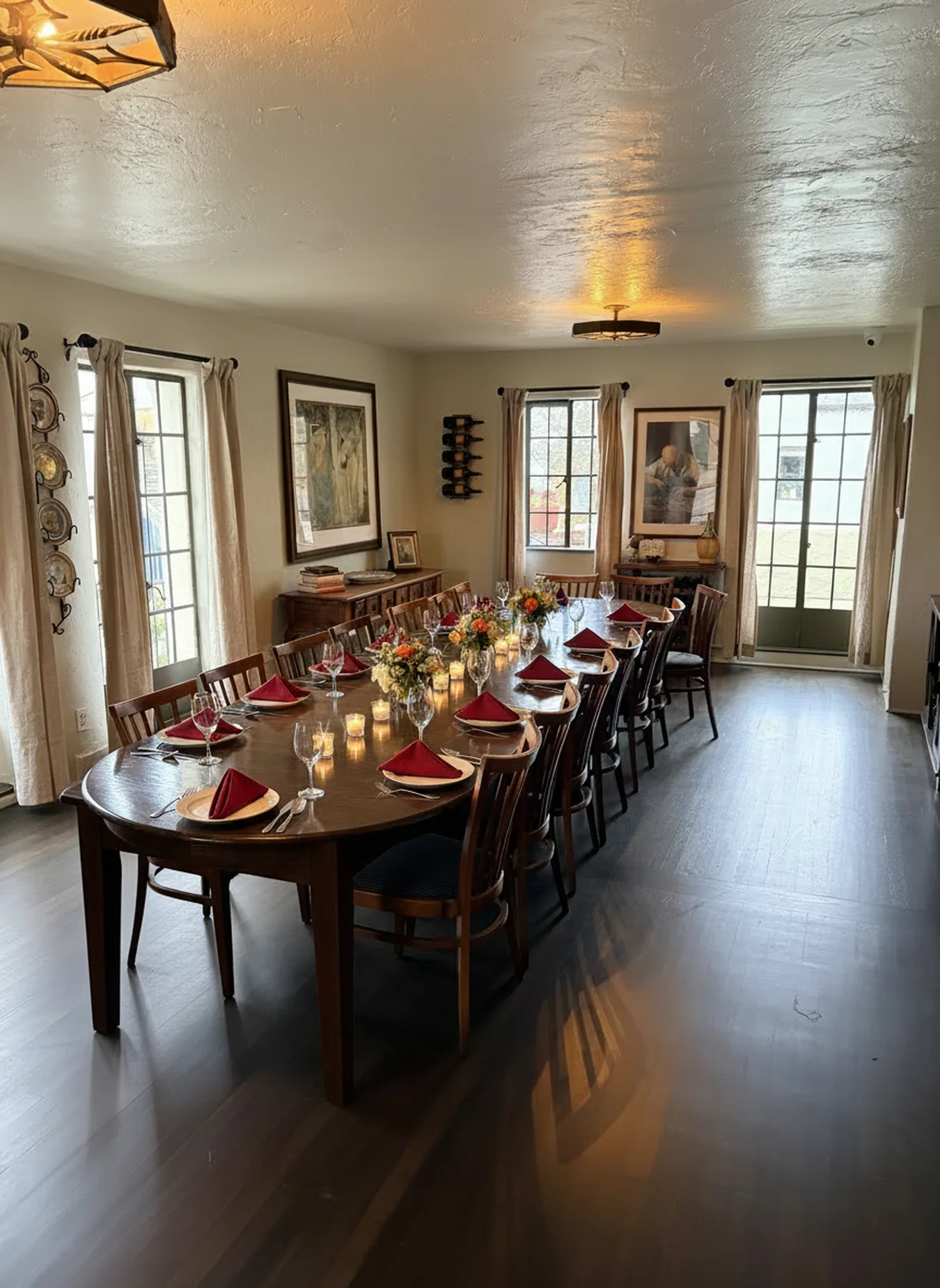 La Dolce Vita, the private dining room at Little Napoli, with the long wood table set for dinner: red napkins, candles and flowers