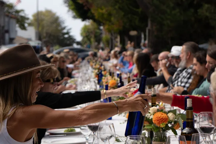 Guests at a long table set down the street outside Vesuvio.