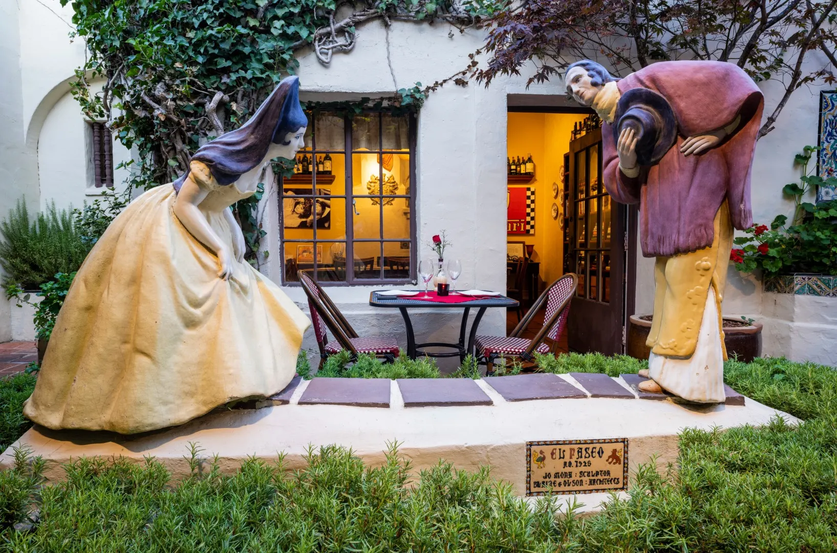 The Greeting, Jo Mora's sculpture in the El Paseo courtyard: a woman in a wide skirt and a man bowing to her