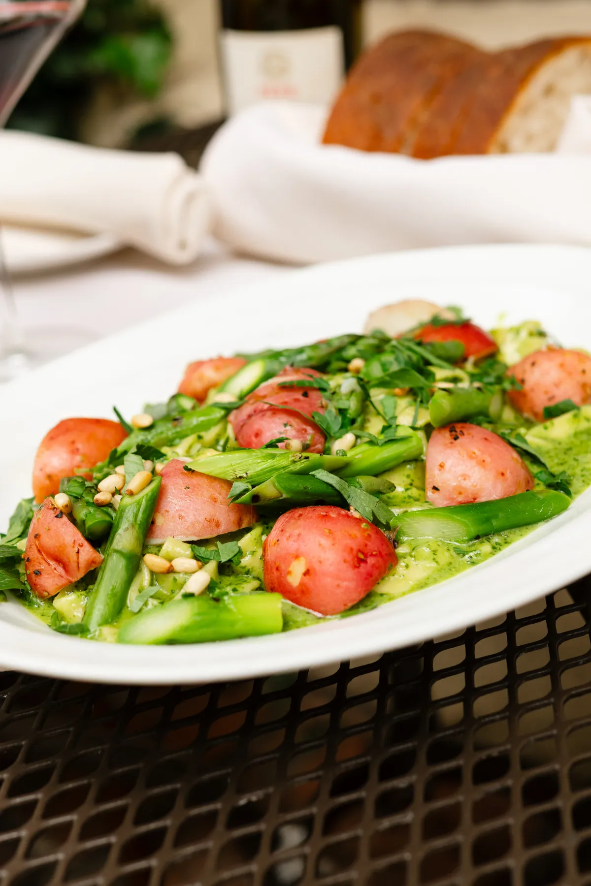 Pesto Genovese at Little Napoli: tagliatelle in creamy basil pesto with asparagus, potatoes and pine nuts, on a courtyard table