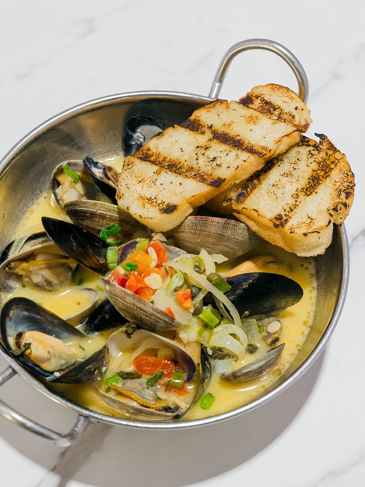 Sauté Damiani at Little Napoli: clams and mussels in saffron cream with grilled crostini